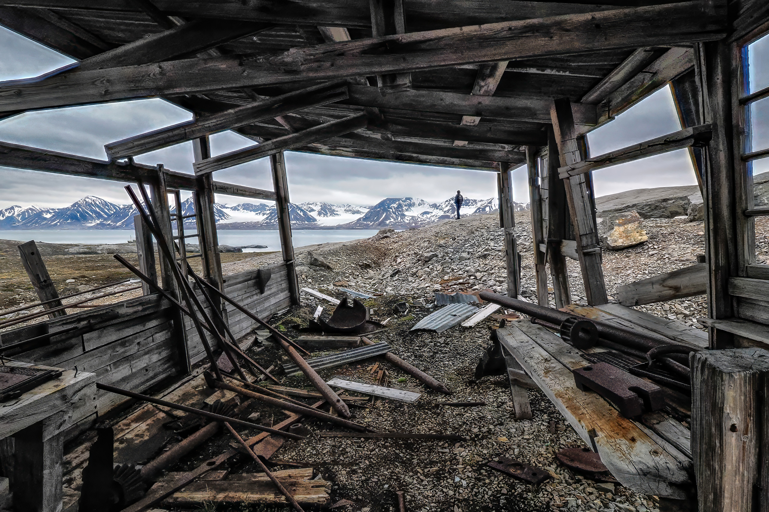 Looking out through the timbers of a ruined trapper's hut