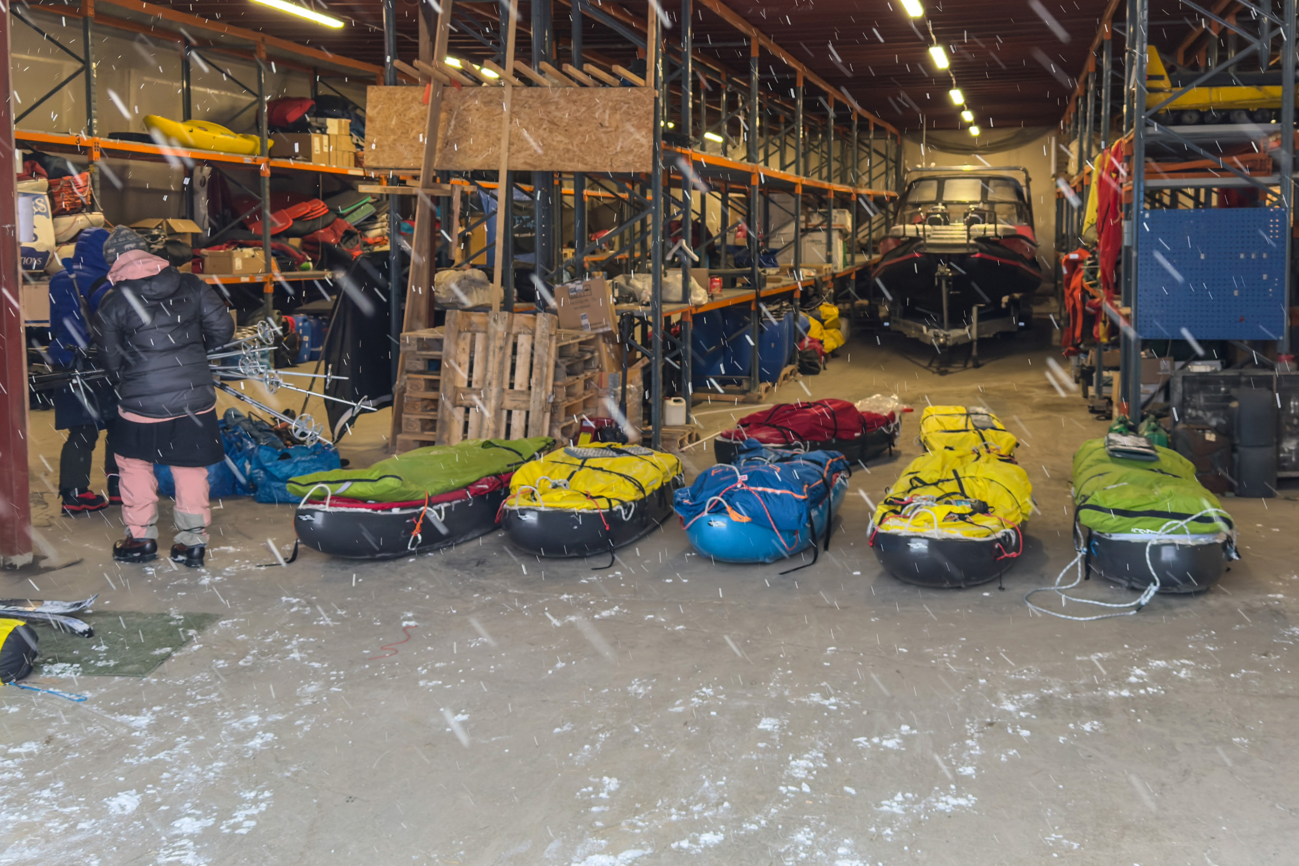 The gear warehouse in Longyearbyen, sleds and kit laid out