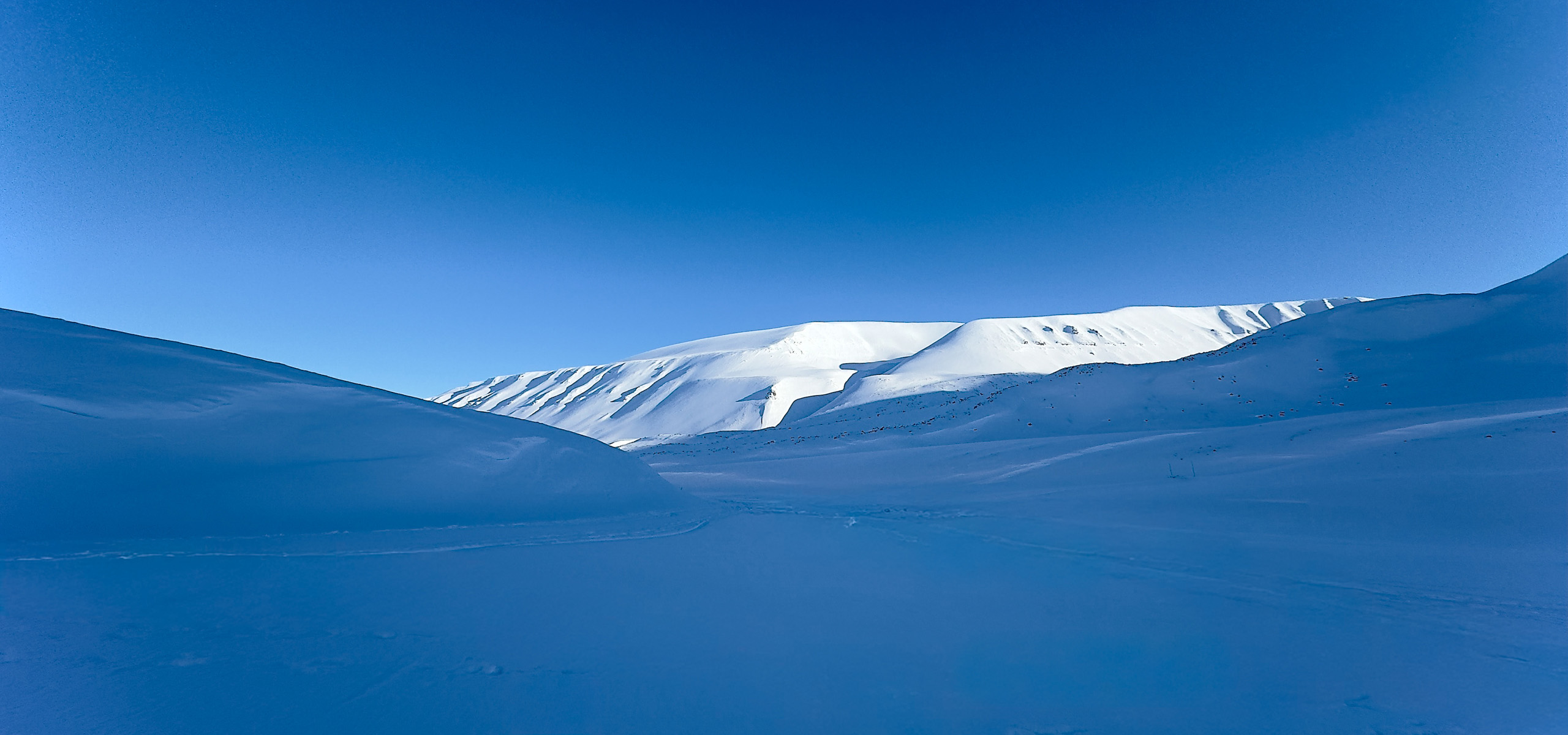 Snow-covered peaks above the ice in Svalbard